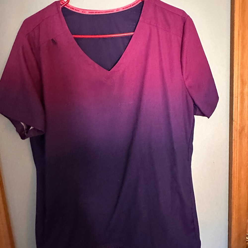 3 Women's Scrub tops with 2 pairs of black jogger scrub pants.